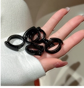 Detailed view of stackable black agate rings with glossy minimalist finish on hand