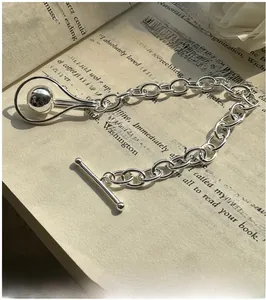 Detail of S925 silver minimalist OT clasp bracelet with metal bead in droplet frame