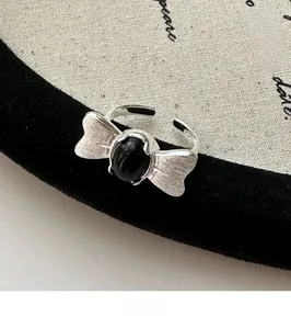 Macro shot of S925 sterling silver butterfly ring with black agate and brushed finish