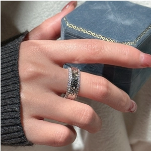 Close-up of wide S925 sterling silver ring with multi-row pavé-set shimmering zircons