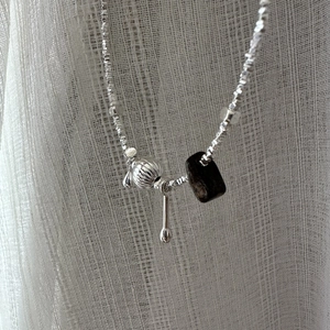 S925 sterling silver beaded necklace with pumpkin bead and teardrop pendant on white fabric