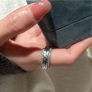 Macro shot of wide S925 silver band ring with multiple rows of sparkling zircon stones