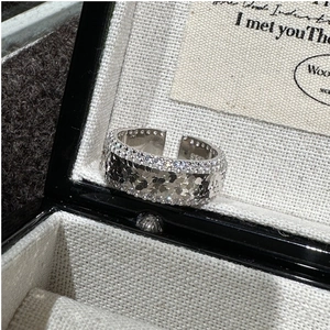 Macro shot of S925 sterling silver open ring with hammered texture and pave zircon
