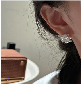 Detail of S925 sterling silver twisted rope knot stud earring on model ear profile