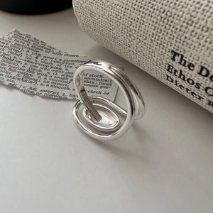 Minimalist S925 sterling silver double-line oval ring on vintage newspaper background