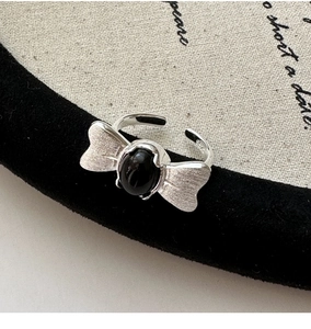 Macro detail of S925 sterling silver butterfly ring with brushed finish and black onyx stone