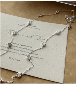 Macro shot of silver S925 sterling silver chain necklace with zircon bezel settings