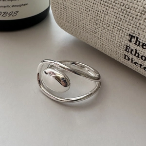 Minimalist S925 sterling silver oval ring with elegant intertwined band on white surface