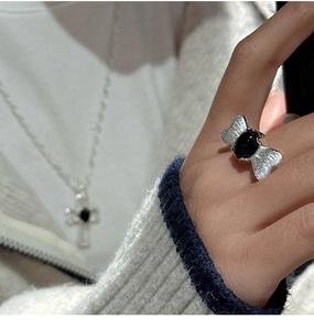 Detail of S925 sterling silver butterfly ring with black agate stone on model hand