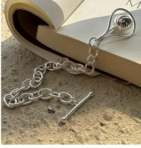 Detailed shot of S925 sterling silver beaded bracelet with toggle clasp and ball pendant