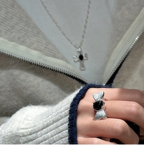 Close-up of S925 silver butterfly ring with black onyx and pavé micro-diamonds