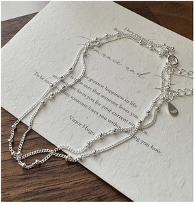 Detailed macro shot of S925 sterling silver layered bead necklace with S925 hallmark