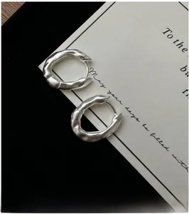 Detailed close-up of S925 sterling silver hoop earrings with irregular matte texture