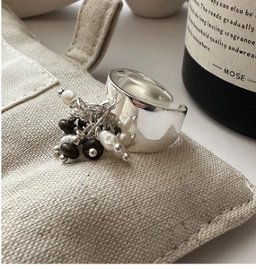 Dettaglio dell'anello largo in argento S925 con nappe pendenti in perle e perline