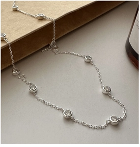Close-up of S925 sterling silver chain featuring bezel-set round zircon gemstones