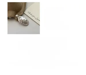 Macro detail of S925 sterling silver textured oval pendant with 25.9mm x 14.4mm dimensions