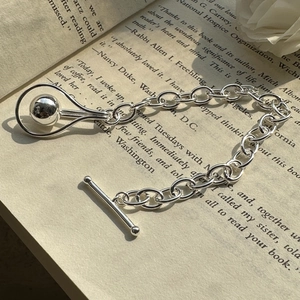 Minimalist S925 sterling silver beaded bracelet with OT clasp on vintage book pages
