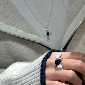 S925 silver butterfly ring with black onyx and paved stones on model's hand