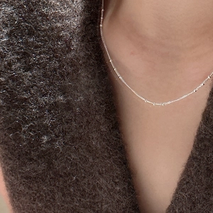 Minimalist S925 sterling silver satellite chain necklace with delicate beads on model neck