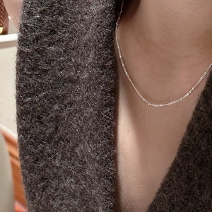 S925 sterling silver minimalist bead chain necklace shown on a model with elegant wool coat