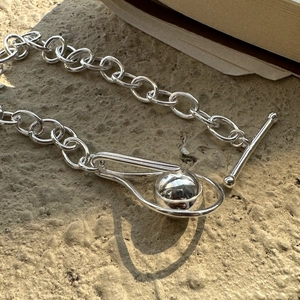 Minimalist S925 sterling silver bead bracelet with T-bar clasp on a stone background