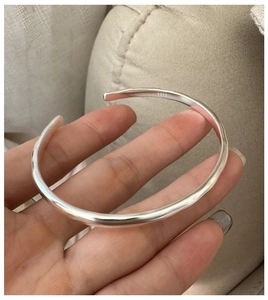 Close-up of S925 sterling silver open cuff bracelet with matte irregular texture