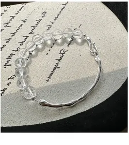 Detail of S925 silver wavy bangle bracelet with clear crystal beads and S-hook clasp