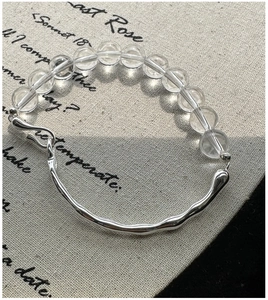 Detail of S925 silver bracelet with white crystals and unique wave metal bar