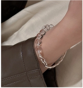 Detail of S925 silver bracelet with white crystal beads and textured metal on wrist