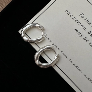 S925 sterling silver earrings featuring irregular lava texture and matte finish on black velvet