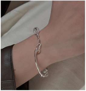 Detail view of S925 silver bracelet with clear crystals on wrist with leather sleeve