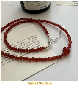 Detail of red agate beaded necklace with S925 sterling silver clasp and logo tag