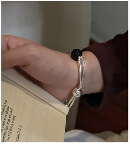 Detail of S925 sterling silver beaded bracelet with black onyx beads worn on wrist