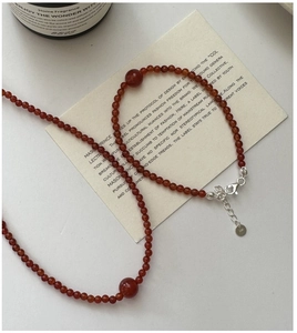 Macro detail of red agate beaded bracelet with S925 silver clasp and adjustable chain