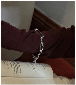 Artistic close-up of S925 sterling silver knotted toggle bracelet with unique links