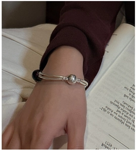 Close-up of S925 sterling silver double-layered bangle with black agate beads on wrist
