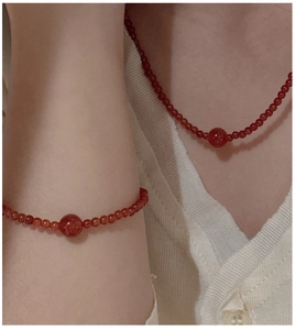 Detailed view of S925 silver red agate beaded necklace and bracelet set on a person
