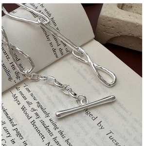 Detail of S925 silver knot bracelet with irregular lava texture and OT toggle clasp