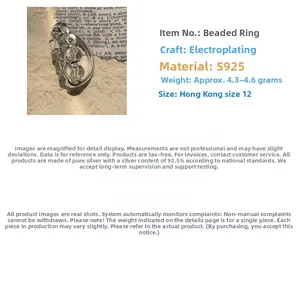 Detail specifications of S925 silver beaded ring with white crystal on newspaper backdrop