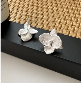 Macro detail of S925 sterling silver orchid earrings with matte brushed flower petals
