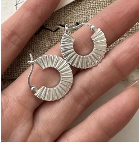 Detail of S925 sterling silver hoop earrings with unique vertical pleated texture