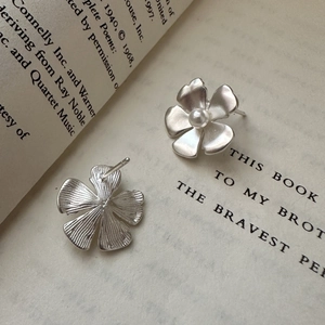 Elegant S925 sterling silver flower earrings with pearl center on vintage book background