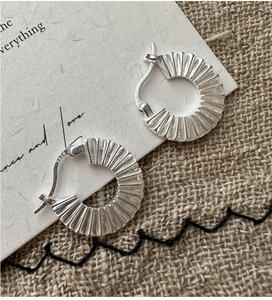 Macro shot of S925 sterling silver hoop earrings with a pleated matte texture finish