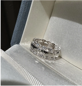 Macro detail of S925 sterling silver hollow interlaced ring with micro-set white zircon stones
