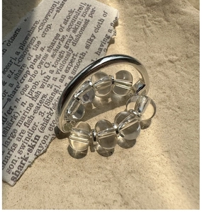 Macro shot of silver beaded stretch ring featuring striped clear crystal quartz accents