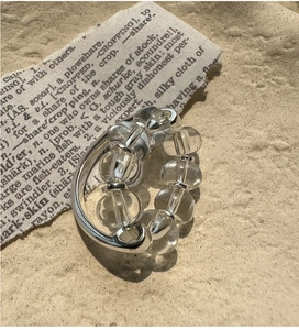 Macro shot of S925 sterling silver ring with clear crystals on vintage paper background