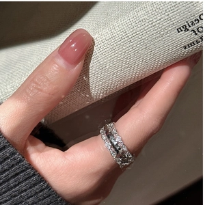 Macro view of S925 sterling silver ring with pavé-set crushed ice crystals and wave lines