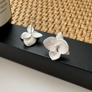 S925 sterling silver matte orchid flower earrings with brushed texture on black stand