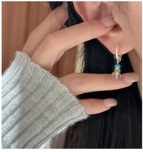 Detail view of S925 sterling silver hoop earrings with three colorful crystal beads