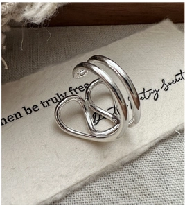 Detailed shot of S925 sterling silver multilayer ring on a vintage aesthetic background